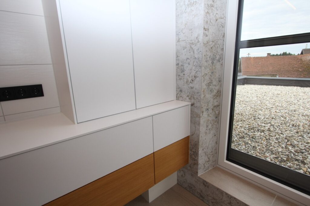 Corian-Fronten und Eiche-Echtholzfurnier im Tischlerbad – maßgefertigte Badeinrichtung OÖ